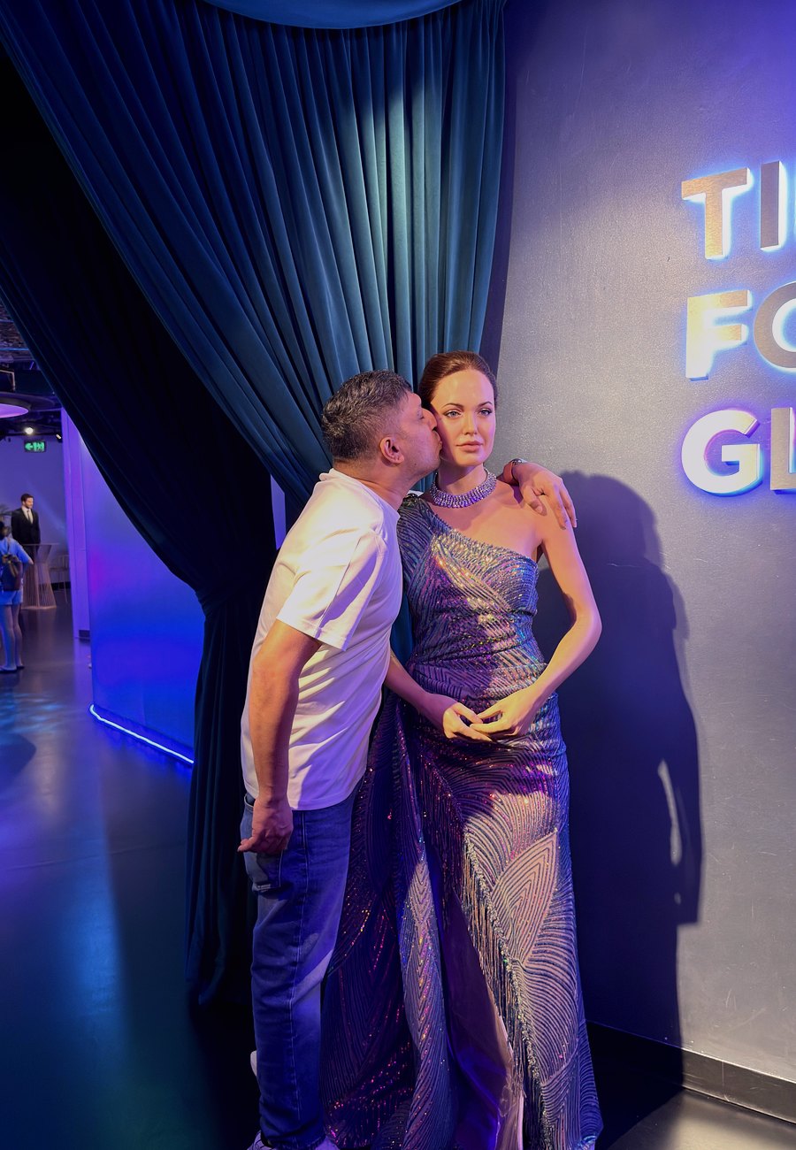 With a wax figure of a silver-screen icon